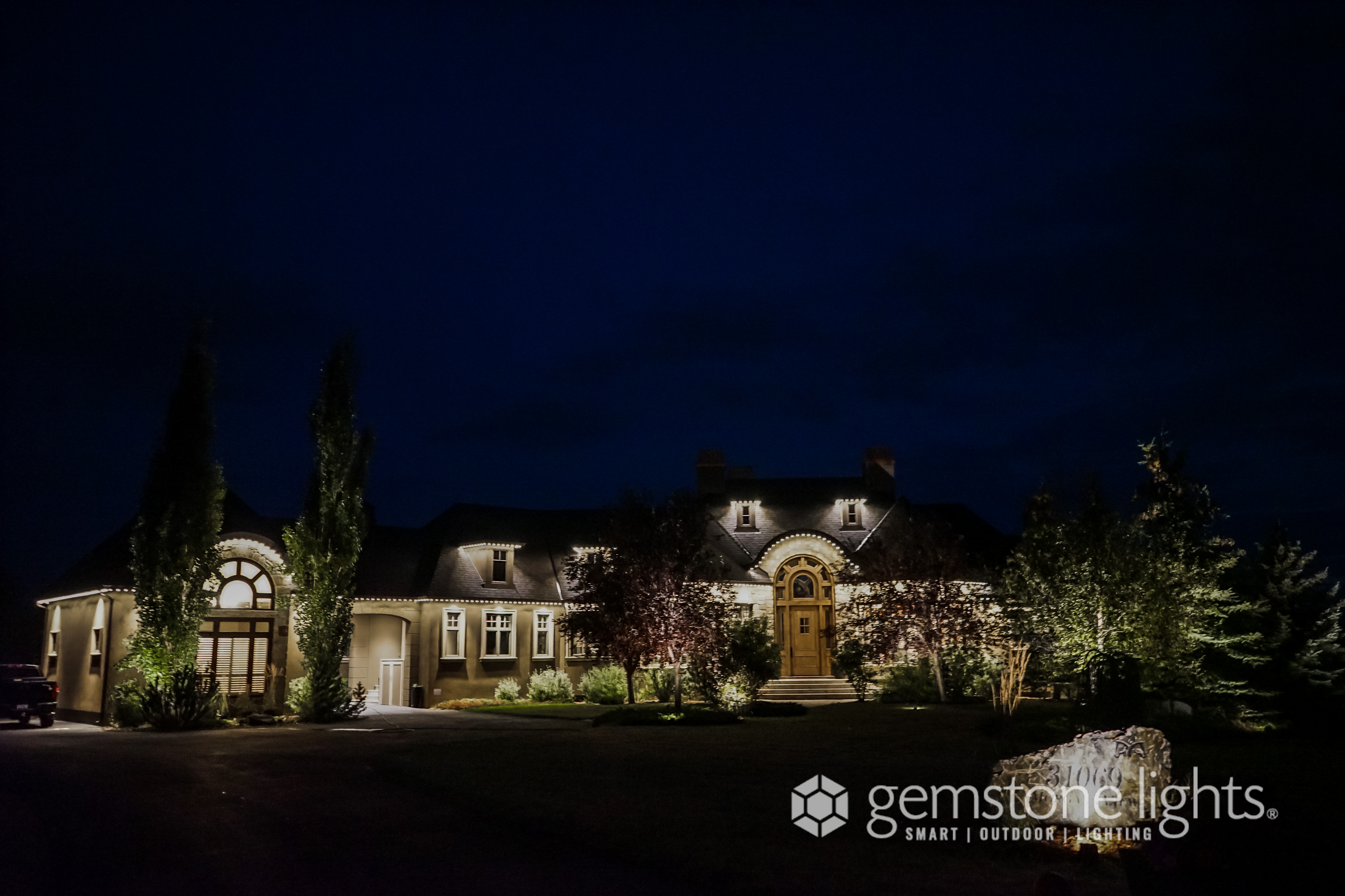 Commercial property with permanent Gemstone Lights flood and roofline LED installation — Calgary Permanent Lights